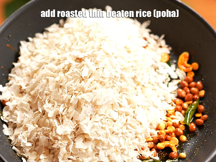 Step 14 – <p>Add the roasted 3 cups thin <a href="https://www.tarladalal.com/glossary-beaten-rice-poha-rice-flakes-flaked-rice-536i"><u>beaten rice (poha)</u></a><u>.</u></p>