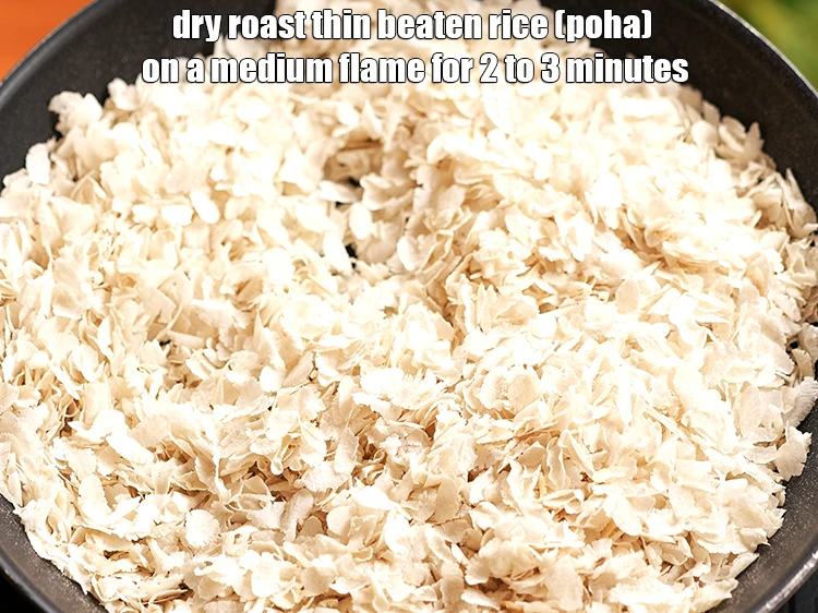 Step 2 – <p><strong>Dry roast </strong><a href="https://www.tarladalal.com/glossary-beaten-rice-poha-rice-flakes-flaked-rice-536i"><strong>beaten rice (poha)</strong></a><strong> </strong>on a medium flame for 2 to 3 minutes, …