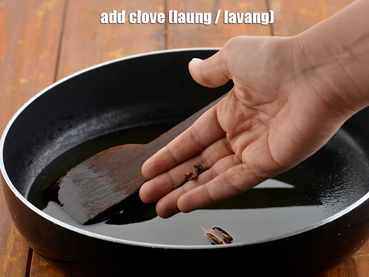 Step 3 – <p>Add 3 <a href="https://www.tarladalal.com/glossary-cloves-laung-lavang-322i"><u>clove (laung / lavang)</u></a><u>.</u></p>