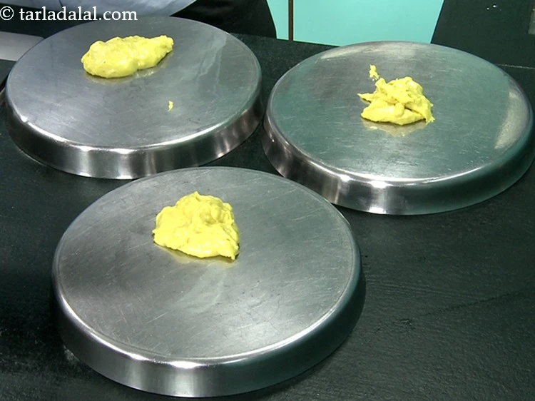 Step 17 – <p>Spread a spoonful of the batter on a greased thali.</p>