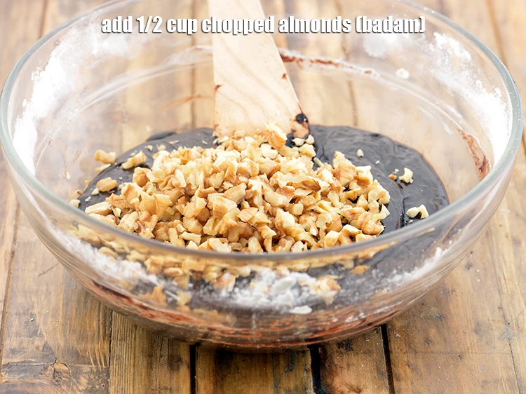 Step 10 – <p>Add 1/2 cup <a href="https://www.tarladalal.com/glossary-almonds-badam-378i#ing_3231"><u>chopped almonds (badam)</u></a>.</p>