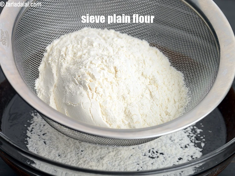 Step 6 – <p><span style="background-color:rgb(255,255,255);color:rgb(0,0,0);">Sieve </span>1/2 cup <a href="https://www.tarladalal.com/glossary-plain-flour-maida-188i"><u>plain flour (maida)</u></a>.</p>