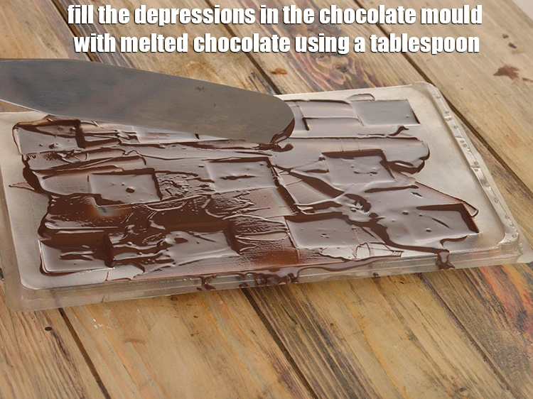 Step 4 – <p><span style="background-color:rgb(255,255,255);color:rgb(0,0,0);">Fill the depressions in the <strong>chocolate mould</strong> with <strong>melted chocolate</strong> using a tablespoon and …
