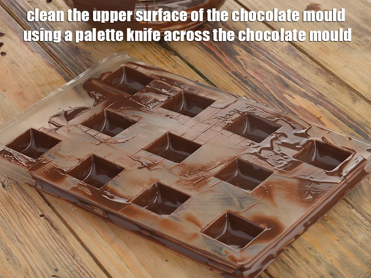 Step 6 – <p><span style="background-color:rgb(255,255,255);color:rgb(0,0,0);">Clean the upper surface of the chocolate mould using a palette knife across the …