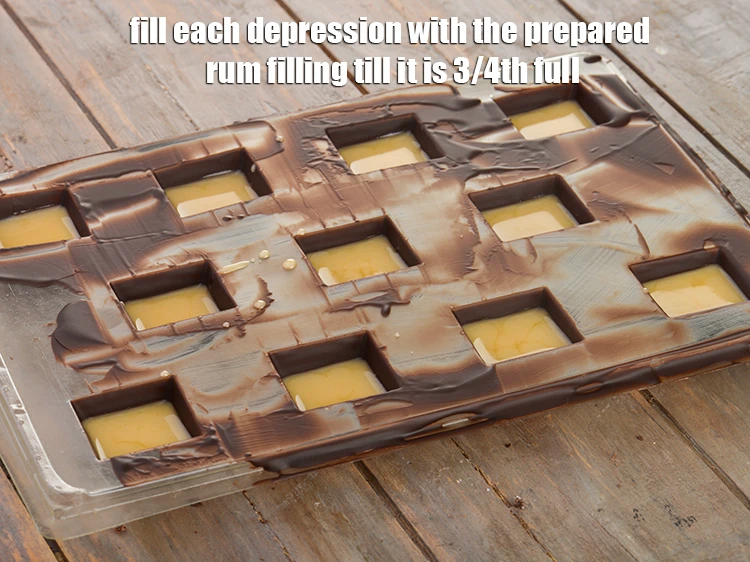 Step 8 – <p><span style="background-color:rgb(255,255,255);color:rgb(0,0,0);">Fill each depression with the <strong>prepared rum filling</strong> till it is 3/4th full.</span></p>