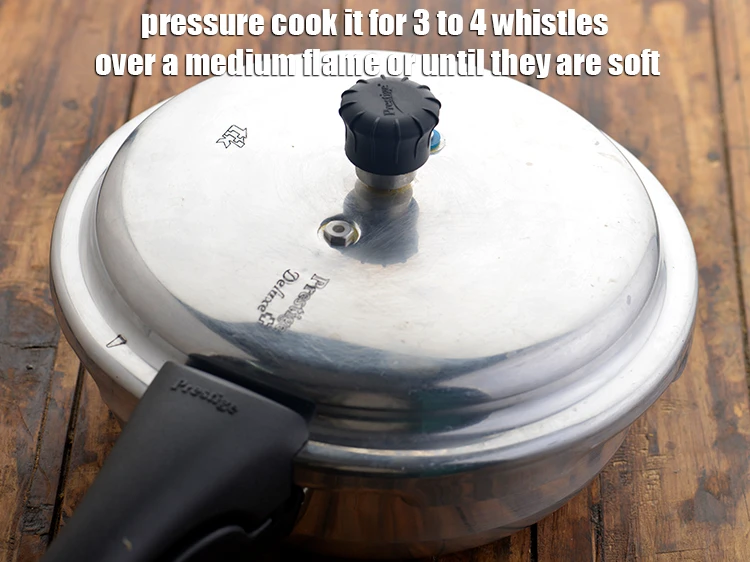Step 7 – <p><strong>Pressure cook</strong> it for 3 to 4 whistles over a medium flame or until they …