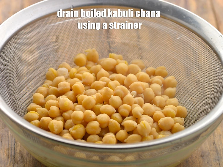 Step 9 – <p>Drain the <strong>boiled kabuli chana</strong> using a strainer and keep aside.</p>