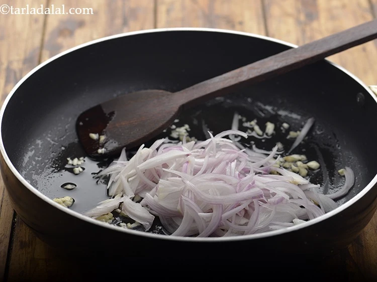 Step 5 – <p>Add the 1/2 cup <a href="https://www.tarladalal.com/glossary-onions-pyaz-pyaaz-kanda-548i#ing_2342"><u>sliced onions</u></a><u>.</u></p>