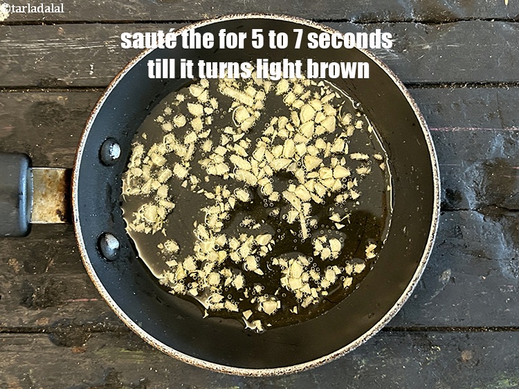 Step 12 – <p>Sauté garlic on medium flame for 5 to 7 seconds till it browns lightly.</p>