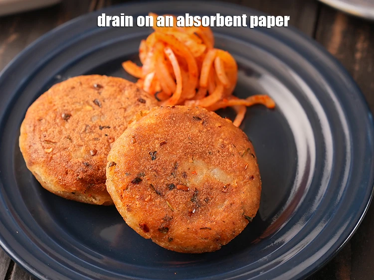 Step 43 – <p>Drain on an absorbent paper. Repeat step 3 to cook the remaining tikkis.</p>