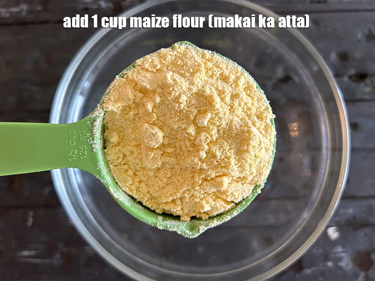 Step 2 – <p>Add 1 cup <a href="https://www.tarladalal.com/glossary-maize-flour-makai-ka-atta-makki-ka-atta-162i"><u>maize flour (makai ka atta)</u></a><u>.</u></p>