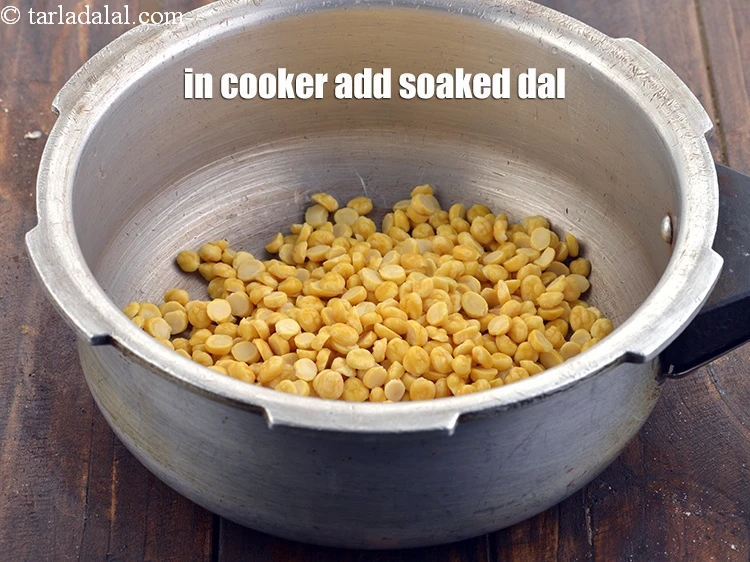Step 7 – <p>In a pressure cooker add the soaked chana dal.</p>