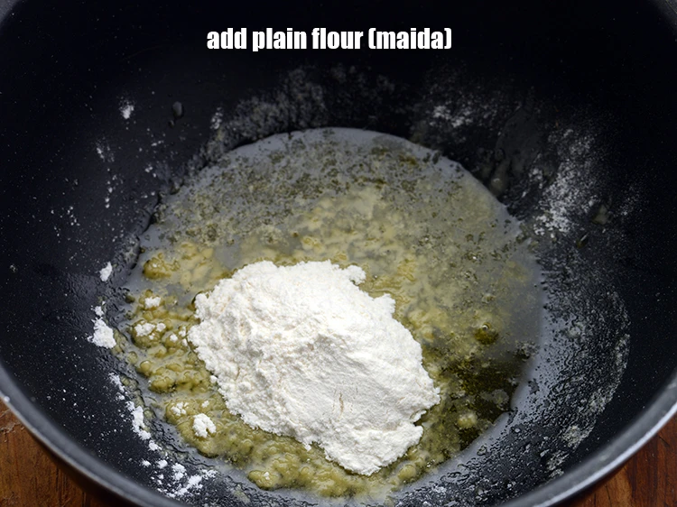 Step 10 – <p><span style="background-color:rgb(255,255,255);color:rgb(0,0,0);">Add </span>1 tbsp <a href="https://www.tarladalal.com/glossary-plain-flour-maida-188i"><u>plain flour (maida)</u></a><span style="background-color:rgb(255,255,255);color:rgb(0,0,0);"> which will help in adding thickness …