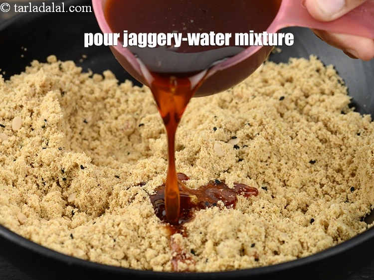 Step 26 – <p>Pour the jaggery-water mixture into the dry ingredients.</p>