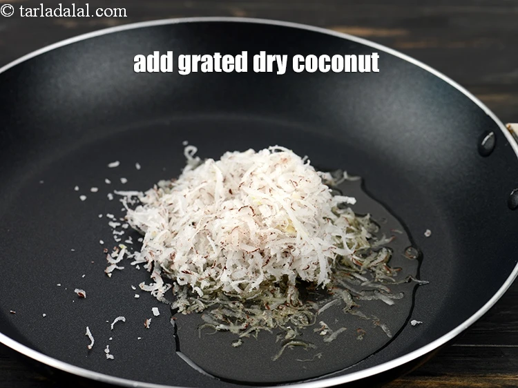 Step 8 – <p>Add 1/2 cup&nbsp;<a href="https://www.tarladalal.com/glossary-grated-dry-coconut-2272i">grated dry coconut (kopra)</a>.&nbsp;</p>