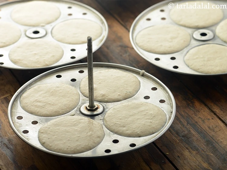 Step 18 – <p>Put spoonfuls of batter into the greased idli moulds.</p>