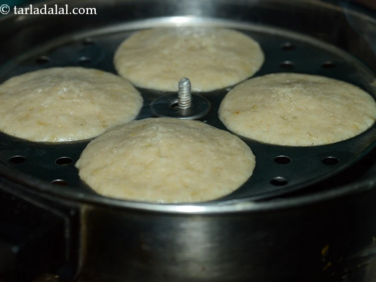 Step 19 – <p>Steam in an idli steamer for 10 to 12 minutes or till they are cooked. …