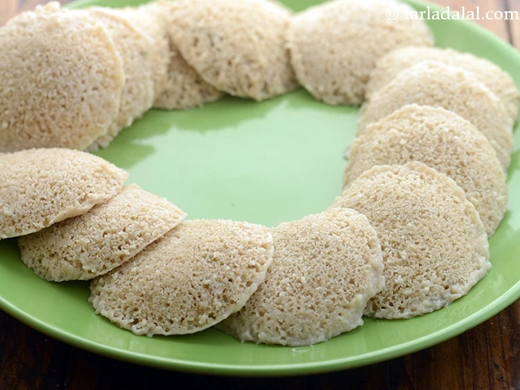 Step 21 – <p>Carefully remove idli moulds from the steamer and let them cool down for 3-4 minutes. …