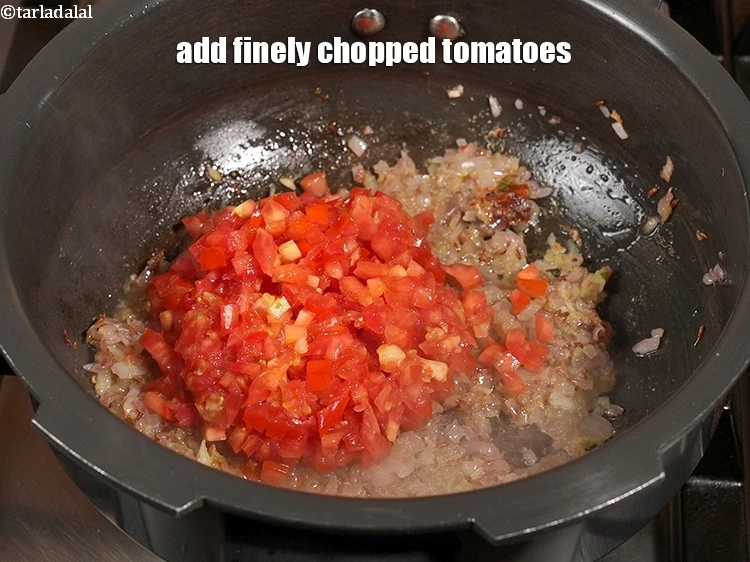 Step 14 – <p>Add 1 cup finely <a href="https://www.tarladalal.com/glossary-chopped-tomatoes-779i">chopped tomatoes</a>.</p>
