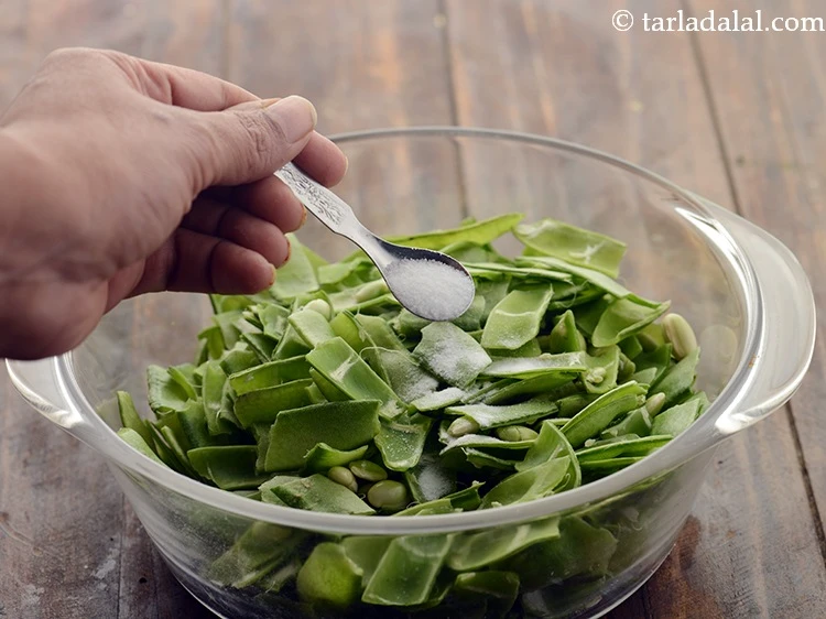Step 3 – <p>Cut each valor papdi into 3 and separate the seeds. Transfer into a deep bowl, …