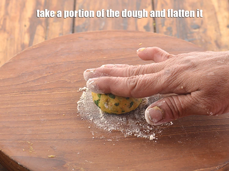Step 21 – <p>Take a portion of the <strong>dough</strong> and <strong>flatten it</strong>.</p>