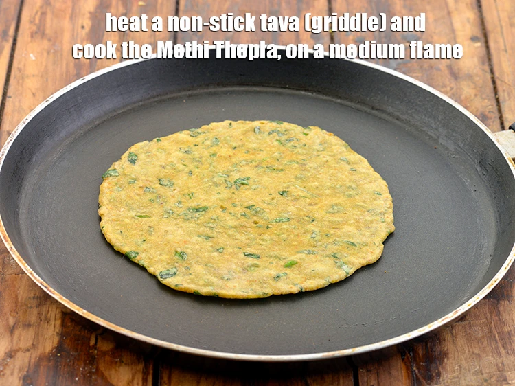 Step 23 – <p>Heat a non-stick tava (griddle) and cook the <strong>Methi Thepla</strong>, on a medium flame.</p>