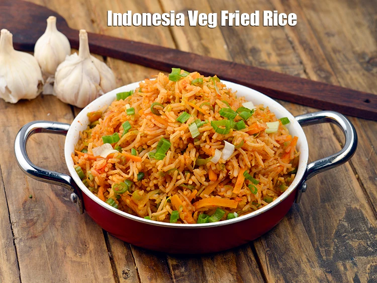 Step 5 – <p><span style="background-color:rgb(255,255,255);color:rgb(0,0,0);">Serve <strong>Nasi Goreng, Indonesia Veg Fried Rice</strong> hot garnished with finely </span><a href="https://www.tarladalal.com/glossary-spring-onion-hara-pyaz-443i#ing_2384"><u>chopped spring …