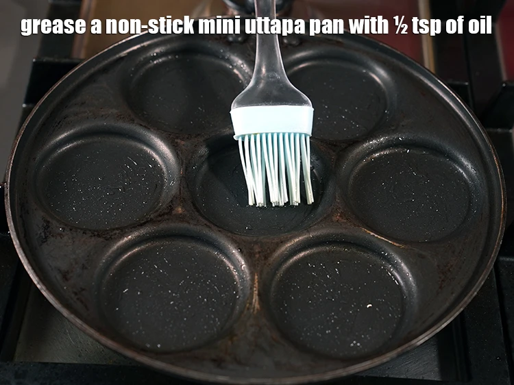 Step 4 – <p><span style="background-color:rgb(255,255,255);color:rgb(0,0,0);">Grease a non-stick <strong>mini uttapa pan</strong> with ½ tsp of </span><a href="https://www.tarladalal.com/glossary-oil-671i"><u>oil</u></a><span style="background-color:rgb(255,255,255);color:rgb(0,0,0);">.</span></p>