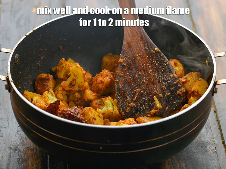 Step 22 – <p>Mix&nbsp;well and <strong>cook</strong> on a medium flame for 1 to 2 minutes, while stirring occasionally.</p>