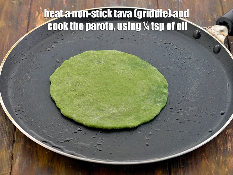 Step 12 – <p><span style="background-color:rgb(255,255,255);color:rgb(0,0,0);">Heat a non-stick tava (griddle) and cook the <strong>parota</strong>, using ¼ tsp of </span><a …