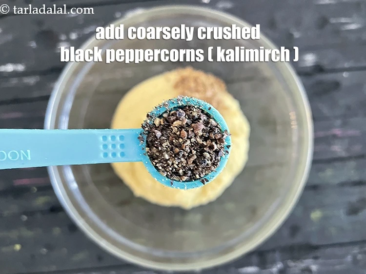 Step 16 – <html><head></head><body><p>Add&nbsp;1/2 tsp&nbsp;coarsely&nbsp;<a href="glossary-crushed-black-pepper-568i">crushed black peppercorns (kalimirch)</a>.</p></body></html>