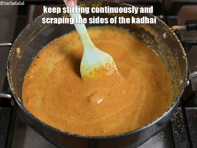 Step 14 – <p><span style="background-color:rgb(255,255,255);color:rgb(0,0,0);">Keep stirring continuously and scraping the sides of the kadhai.</span></p>