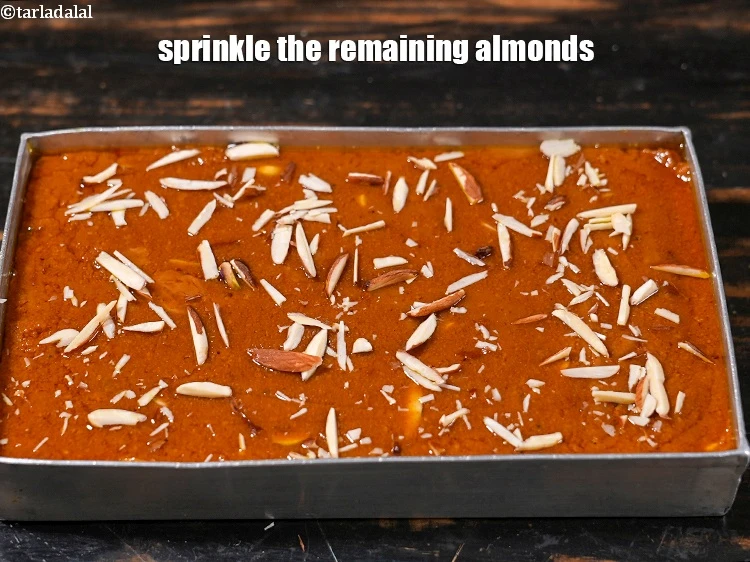 Step 28 – <p>Sprinkle the remaining 1 tbsp&nbsp;<a href="https://www.tarladalal.com/glossary-almonds-badam-378i">almonds (badam)</a>.&nbsp;</p>
