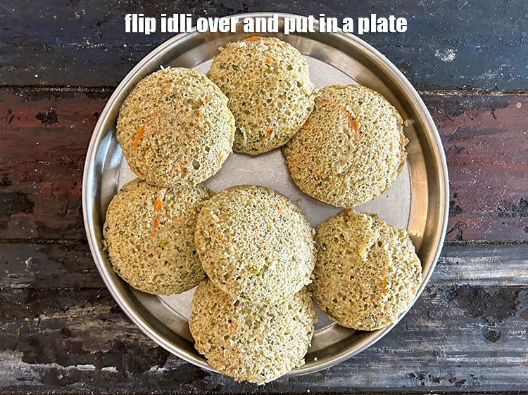 Step 33 – <p>Flip the <strong>green moong dal vegetable idli&nbsp;</strong>over and put&nbsp;in a plate. See the nice jali …