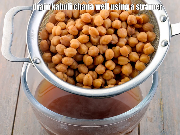 Step 13 – <p><strong>Drain</strong> the kabuli chana well using a strainer. You can reserve the water and use …