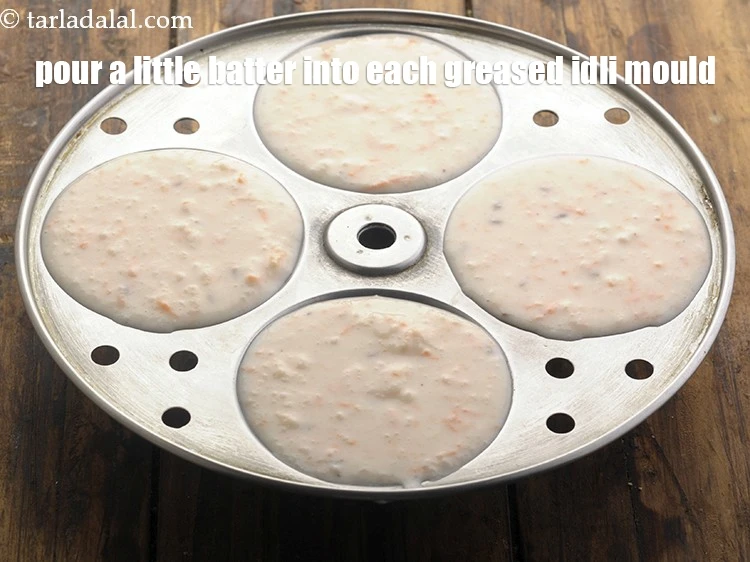 Step 25 – <html><head><meta charset="UTF-8"></head><body><p>Pour a little batter into each greased idli mould.&nbsp;<br>&nbsp;</p></body></html>