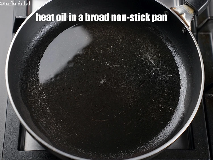 Step 8 – <p>To make <strong>vermicelli idli recipe</strong>, heat 4 tbsp of oil in a broad non-stick pan.</p>