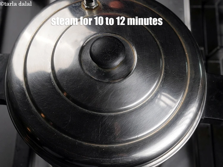 Step 30 – <p>Steam in a steamer for 10 to 12 minutes or till the idlis are cooked.</p>