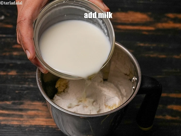 Step 12 – <p>Add1/2 cup <a href="https://www.tarladalal.com/glossary-milk-doodh-full-cream-milk-514i"><u>milk</u></a><u>.</u></p>