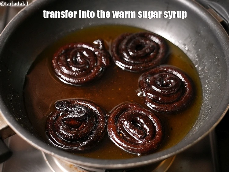 Step 19 – <p>Drain them well. Transfer into the warm sugar syrup.</p>