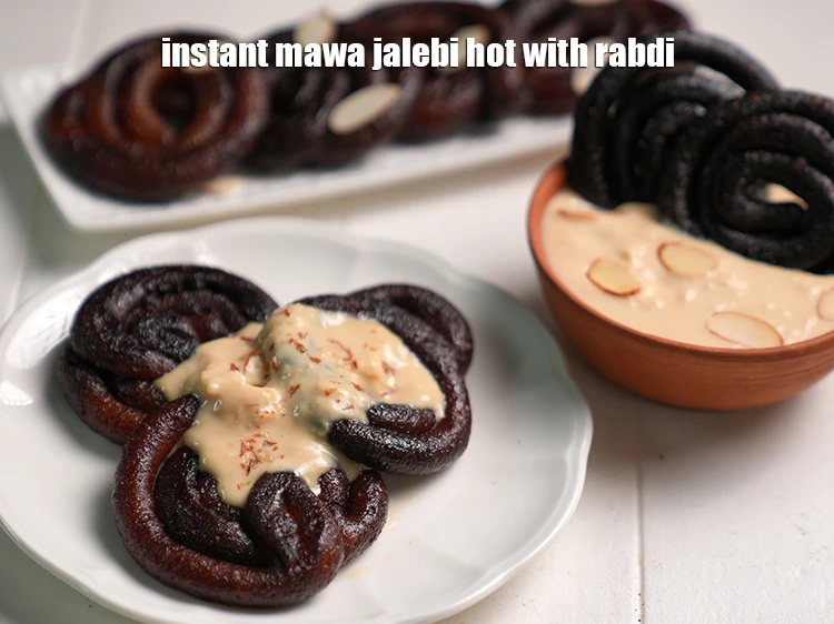 Step 21 – <p><span style="background-color:rgb(255,255,255);color:rgb(0,0,0);">Serve the </span><strong>mawa jalebi</strong><span style="background-color:rgb(255,255,255);color:rgb(0,0,0);"> hot with </span><a href="https://www.tarladalal.com/rabri-or-how-to-make-rabdi-1099r"><strong><u>rabdi</u></strong></a><span style="background-color:rgb(255,255,255);color:rgb(0,0,0);">.</span></p>