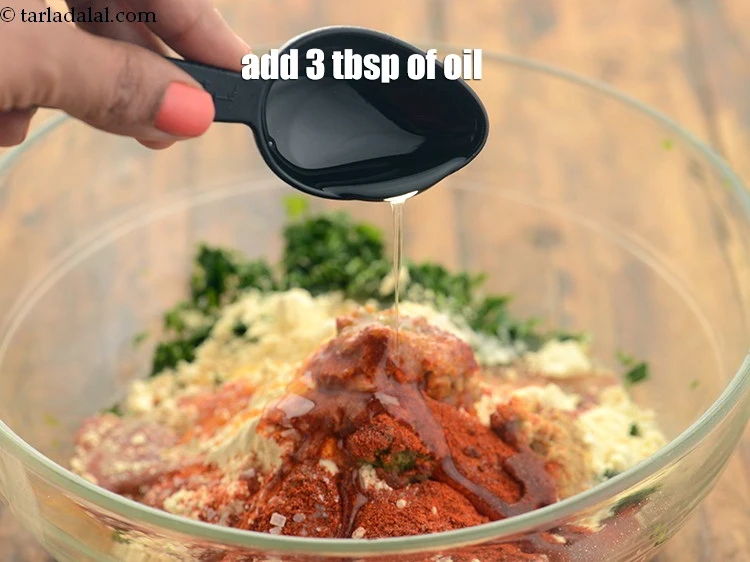 Step 15 – <p>Add 3 tbsp <a href="https://www.tarladalal.com/glossary-oil-671i"><u>oil</u></a>. It helps make muthiyas soft and melt in the mouth.</p>