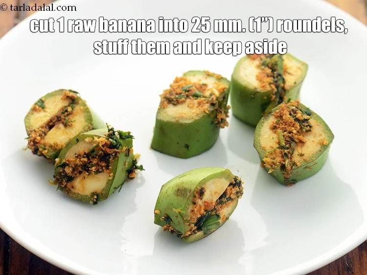 Step 35 – <p>Cut 1 <a href="https://www.tarladalal.com/glossary-raw-banana-kacha-kela-plantain-25i"><u>raw banana</u></a> into 25 mm. (1”) roundals, stuff them and keep aside.&nbsp;</p>