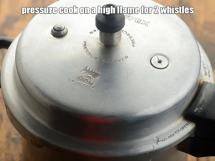 Step 53 – <p>Pressure cook <strong>Oondhiya</strong> on a high flame for 2 whistles.</p>