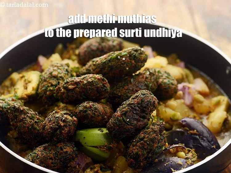 Step 57 – <p>Add methi muthias to the prepared <strong>Surti Undhiya</strong>.</p>