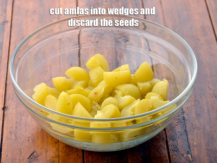 Step 6 – <p>Cut the <strong>amlas</strong> into wedges and discard the seeds.</p>