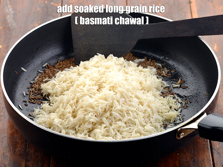 Step 12 – <p><span style="background-color:rgb(255,255,255);color:rgb(0,0,0);">Once the seeds crackle, add the rice.</span></p>