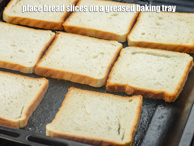 Step 11 – <p>Place the 8 <a href="https://www.tarladalal.com/glossary-bread-219i#ing_3515"><u>bread slices</u></a> on a greased baking tray.&nbsp;</p>