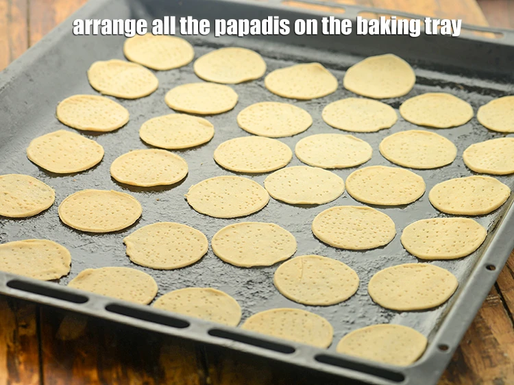 Step 14 – <p>Arrange all the<strong> papadis</strong> on the baking tray.</p>