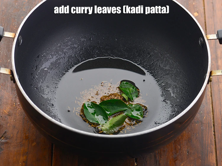 Step 22 – <p>When the seeds crackle, add the 5 to 6 <a href="https://www.tarladalal.com/glossary-curry-leaves-kadi-patta-kadipatta-388i"><u>curry leaves (kadi patta)</u></a><u>.</u></p>